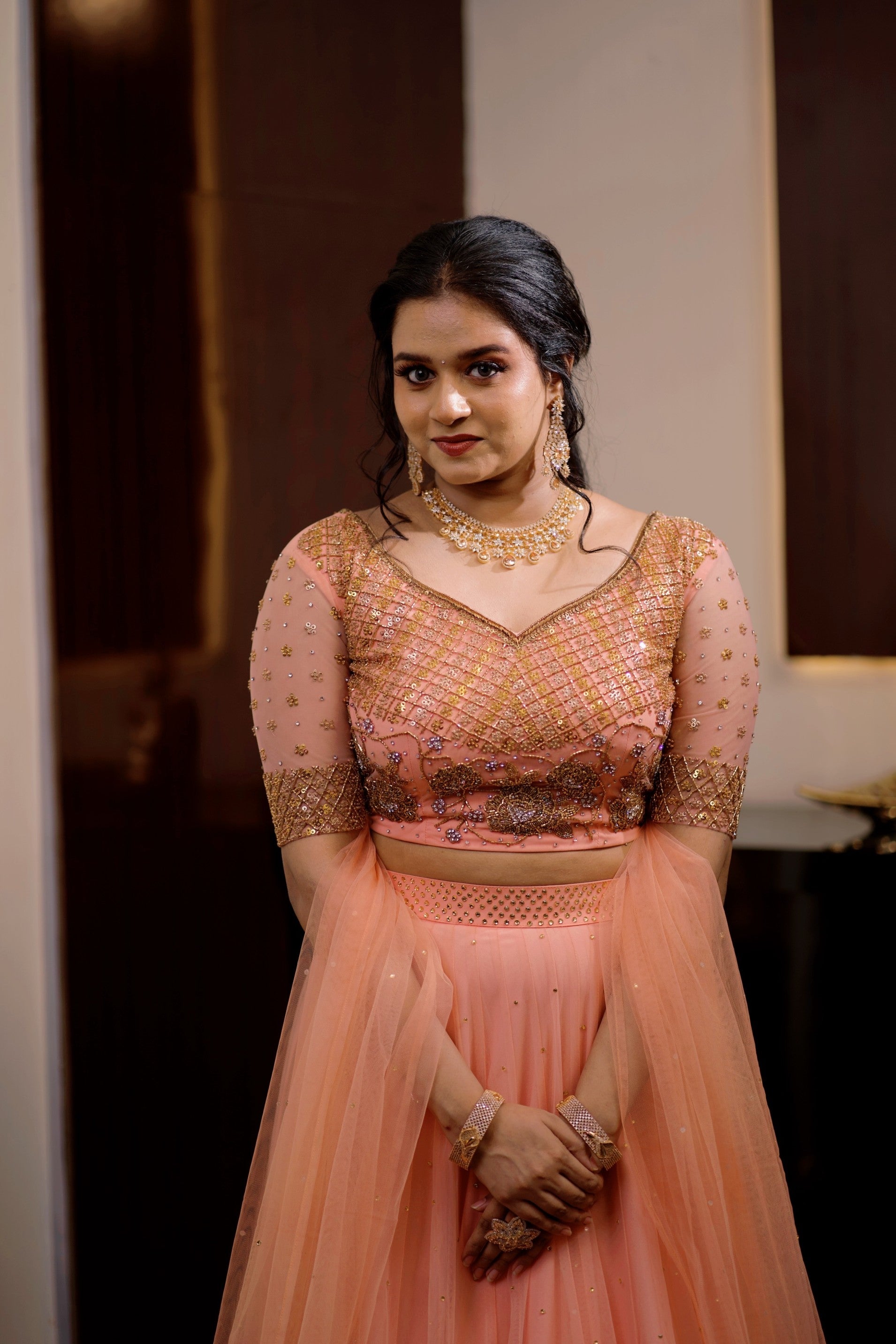 Peach Bridal Lehenga Detailed with Golden Zardozi & Sequence Work
